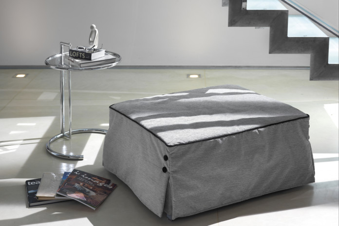 Footstool that turns into a single bed with slatted base and foam mattress