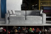 A stylish sofa in grey fabric with leather tape trimmings and piping
