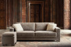 Stylish modern country sofa bed with piped edge cushions and sculptural legs