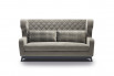 High wingback sofa detailed with a diamond tufted buttonless upholstery