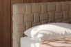 Cocos suspended double bed characterised by a special quilting of the headboard