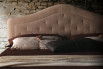 Detail of the tufted arched headboard