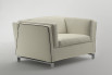 A comfy armchair with feather-wrapped foam cushions and sleek metal legs