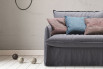 Large snuggle chair with flanged edge cushions and arms